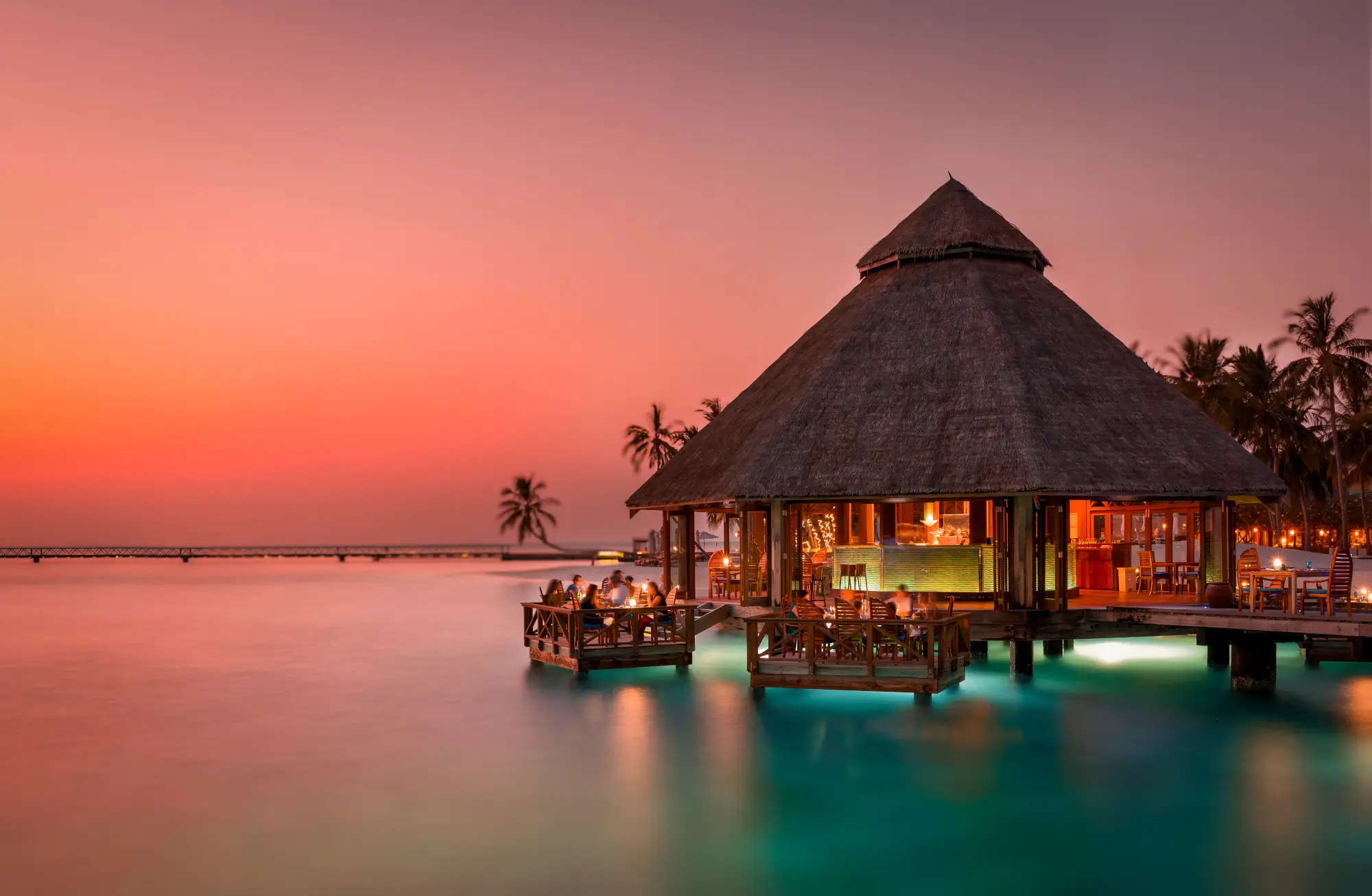 Sunset dining over the lagoon at Conrad Maldives